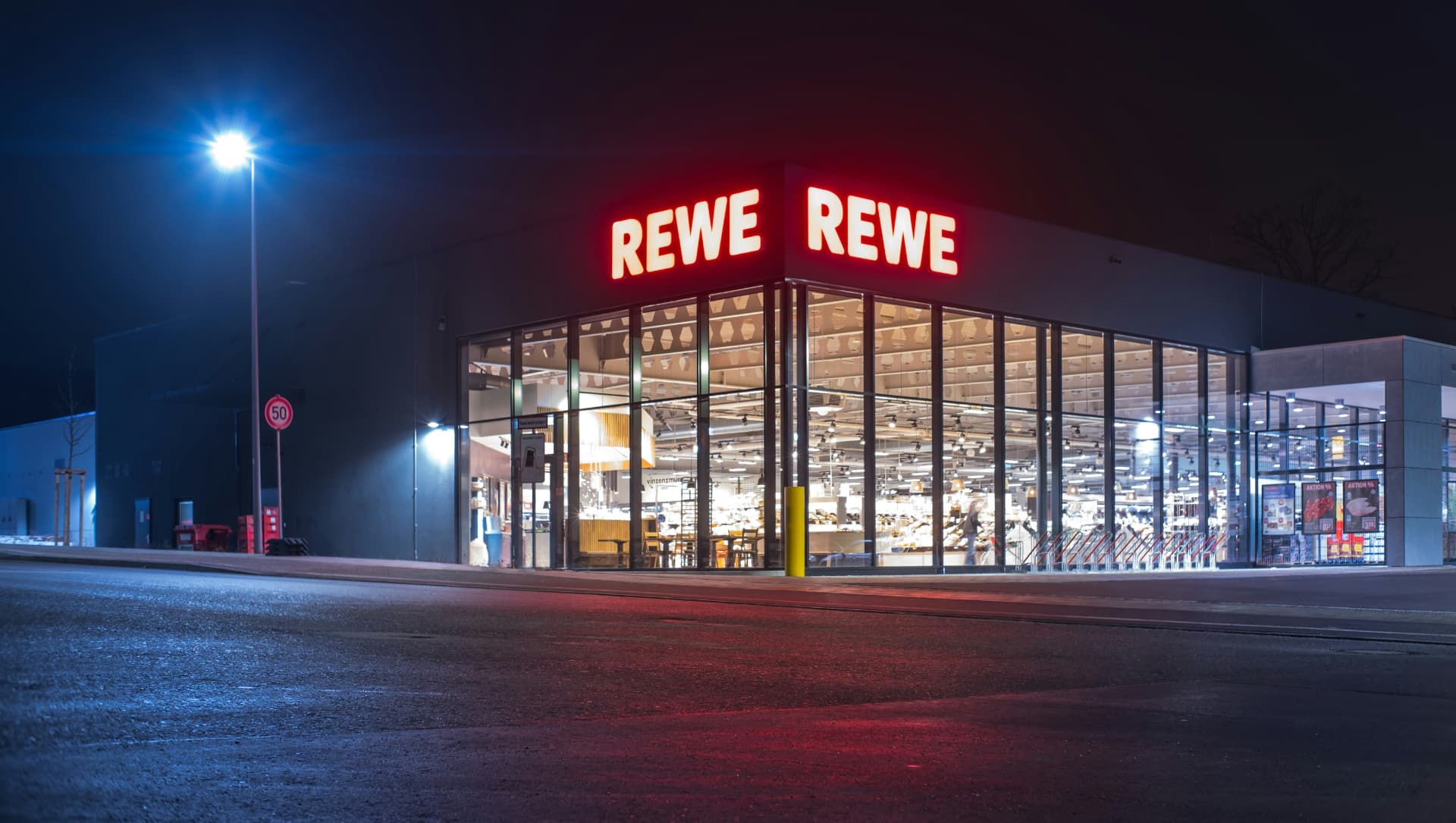 Beleuchtete Einzelhandelsimmobilie bei Nacht